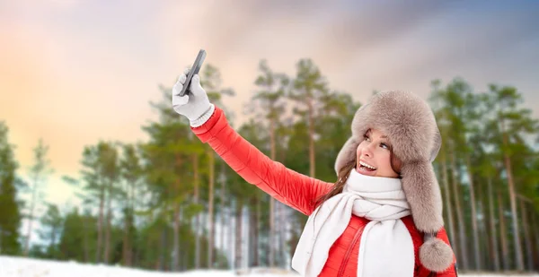 Mujer feliz tomando selfie sobre el bosque de invierno —  Fotos de Stock