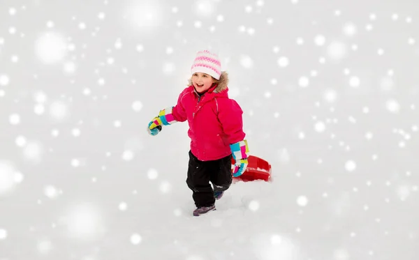 Meisje met slee op sneeuw heuvel in de winter — Stockfoto