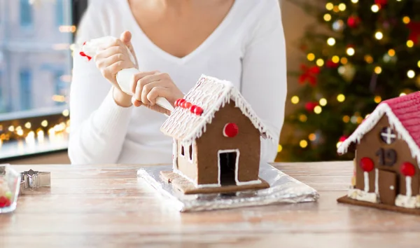 Frau bastelt an Weihnachten Lebkuchenhäuser — Stockfoto