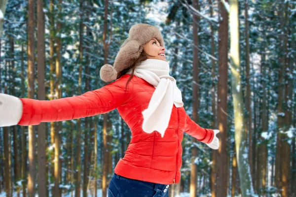Happy woman in fur hat over winter forest — Stock Photo, Image