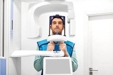 patient having x-ray scanning at dental clinic clipart