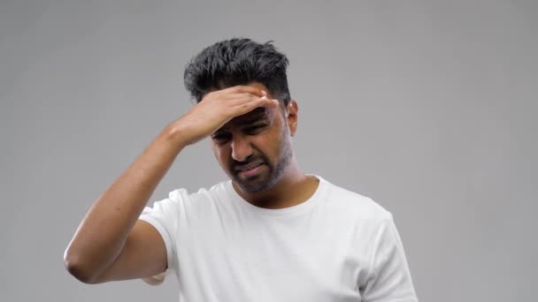 Unhappy indian man suffering from headache — Stock Video