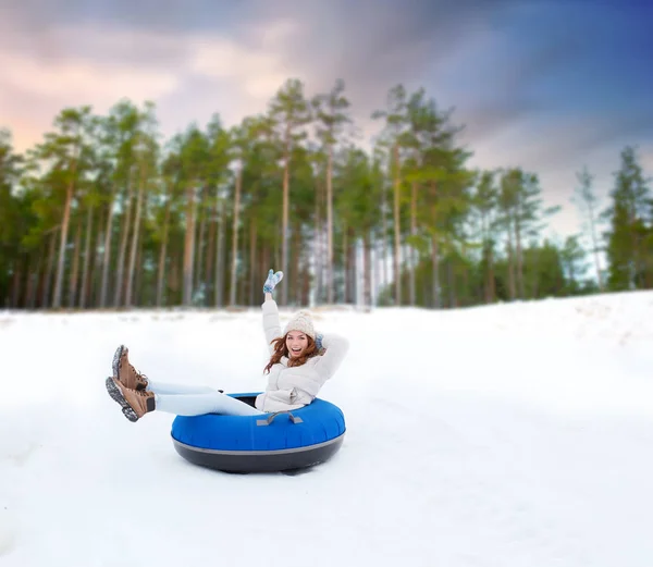 Щаслива дівчина-підліток ковзає по схилу на сніговій трубі — стокове фото