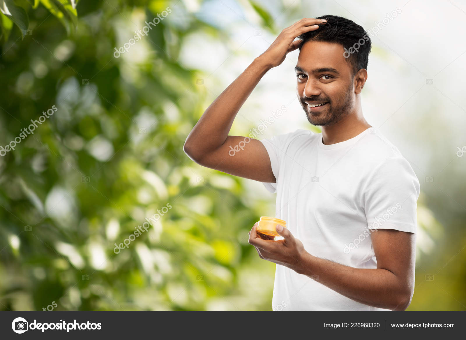 Indian Man Applying Hair Wax Or Styling Gel Stock Photo