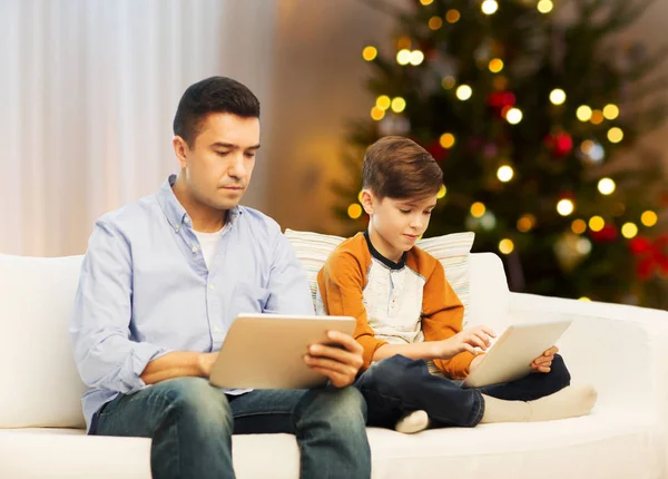 Father and son with tablet computers on christmas — Stock Photo, Image