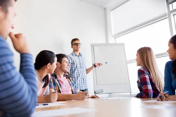 Group of high school students with flip chart — Stock Photo, Image
