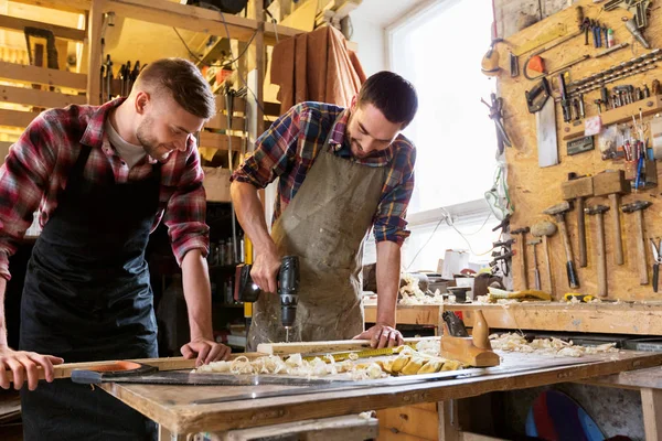 Carpenters working with wooden board at workshop — Stock Photo, Image