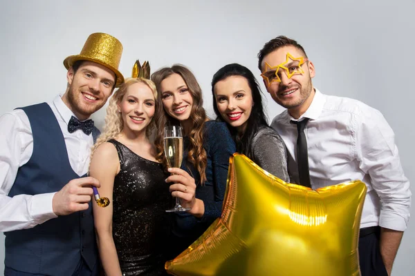 Happy friends with golden party props posing — Stock Photo, Image