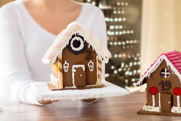 Close up of woman with christmas gingerbread house — Stock Photo, Image