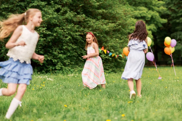 Happy girls playing tag game at birthday party — Stock Photo, Image