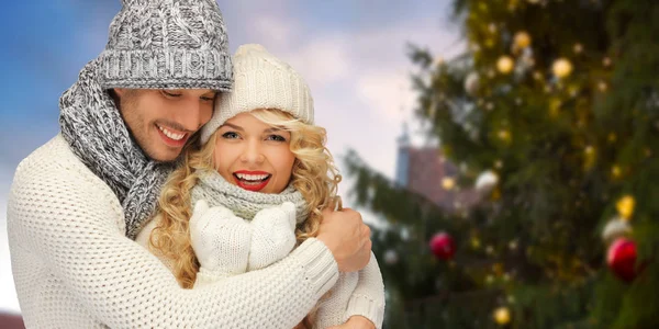 Ευτυχισμένο ζευγάρι αγκαλιάζει πάνω από το χριστουγεννιάτικο δέντρο — Φωτογραφία Αρχείου