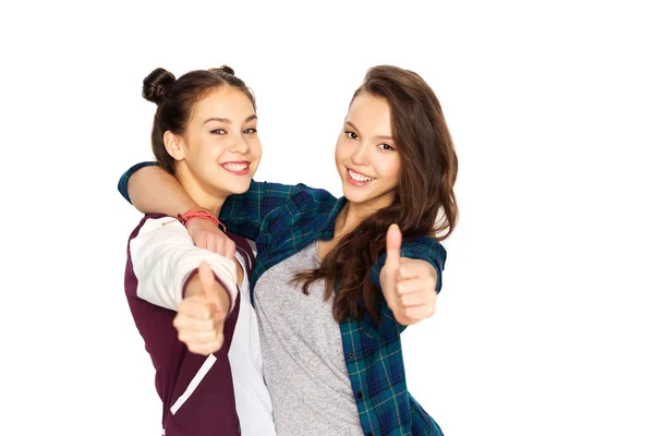 Happy teenage girls hugging and showing thumbs up — Stock Photo, Image