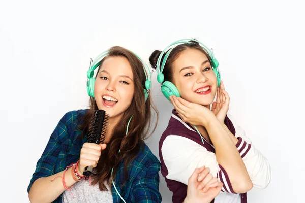 Meninas adolescentes em fones de ouvido ouvindo música — Fotografia de Stock