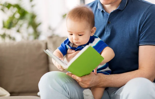 Мальчик и отец с книгой дома — стоковое фото