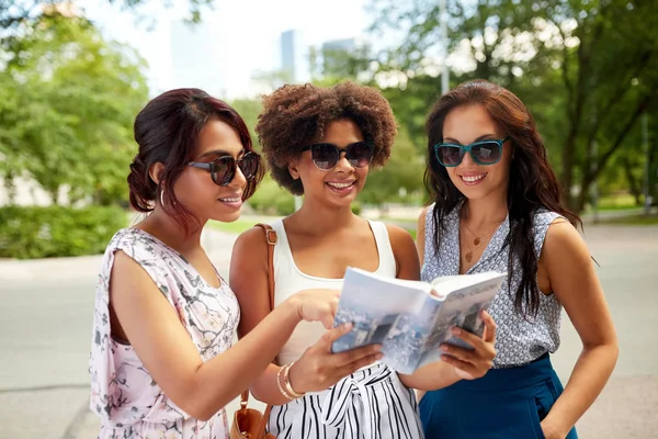 Happy women with city guide on street in summer — Stock Photo, Image