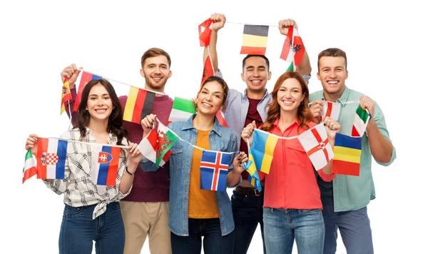 Happy friends with flags of different countries — Stock Photo, Image