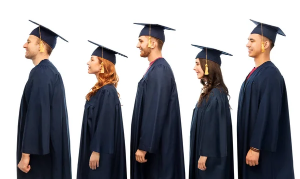 Graduates in mortar boards and bachelor gowns — Stock Photo, Image