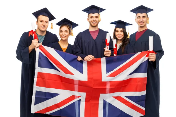 Studenti laureati con diplomi e bandiera britannica — Foto Stock