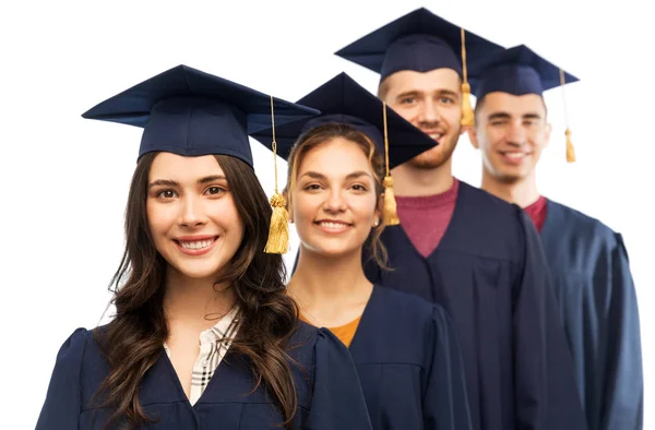 Graduates in mortar boards and bachelor gowns — Stock Photo, Image