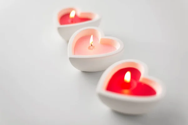 Heart shaped candles burning on valentines day — Stock Photo, Image