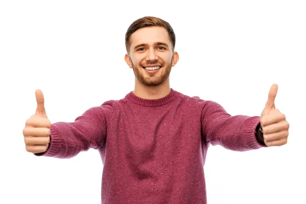 Šťastný mladý muž ukazuje palec — Stock fotografie