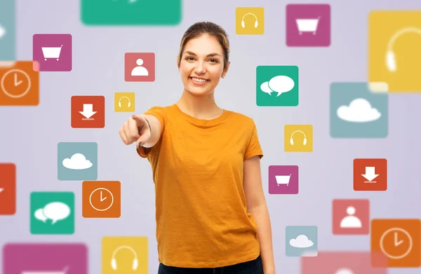 Teenage girl pointing at you over media icons — Stock Photo, Image