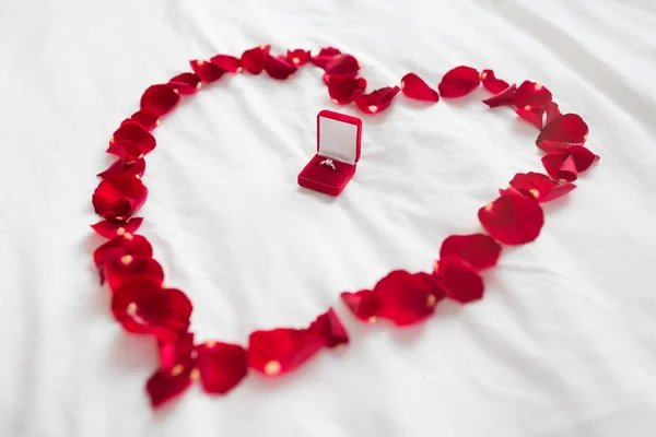 礼品盒中的花瓣和钻石戒指的心脏 — 图库照片