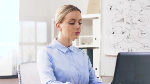 Geschäftsfrau mit Laptop und Smartwatch im Büro — Stockvideo