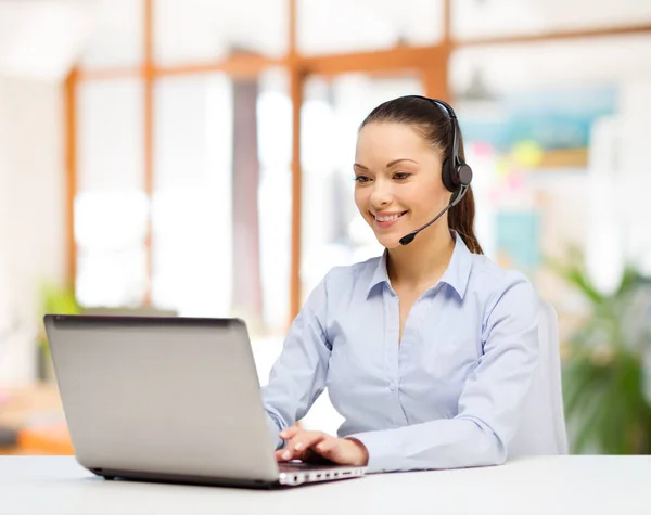 Helpline operator in headset working at office — Stock Photo, Image