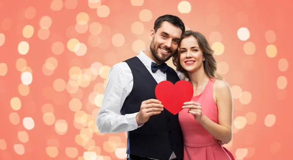 Happy couple with red heart on valentines day — Stock Photo, Image