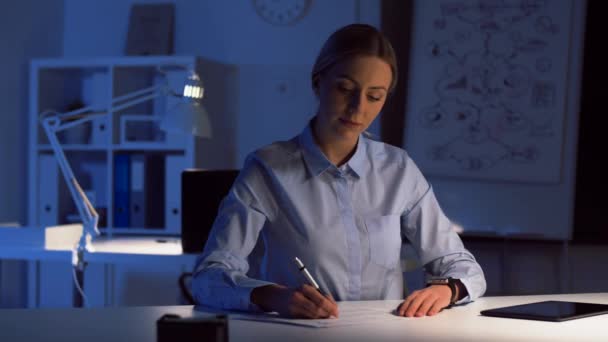 Zakenvrouw met slimme horloge bij nacht kantoor — Stockvideo