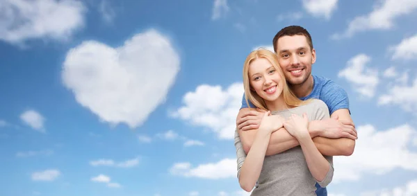 Couple hugging over sky and heart shaped cloud — Stock Photo, Image