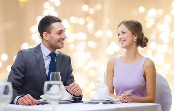 Happy couple at restaurant over festive lights — Stock Photo, Image