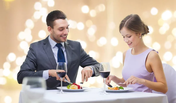 Lächelndes Paar isst Häppchen im Restaurant — Stockfoto