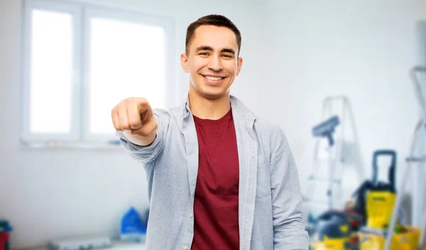 Man pointing to you over home repair background — Stock Photo, Image