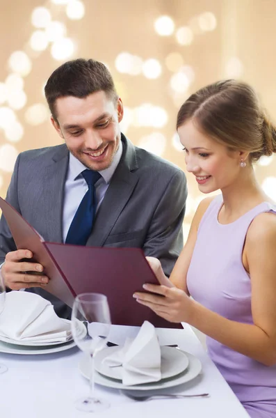 Couple with menu at restaurant — Stock Photo, Image