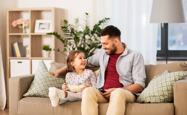 Lycklig far och dotter titta på tv hemma — Stockfoto