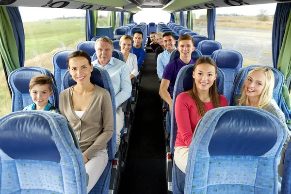 Group of happy passengers travelling by bus — Stock Photo, Image