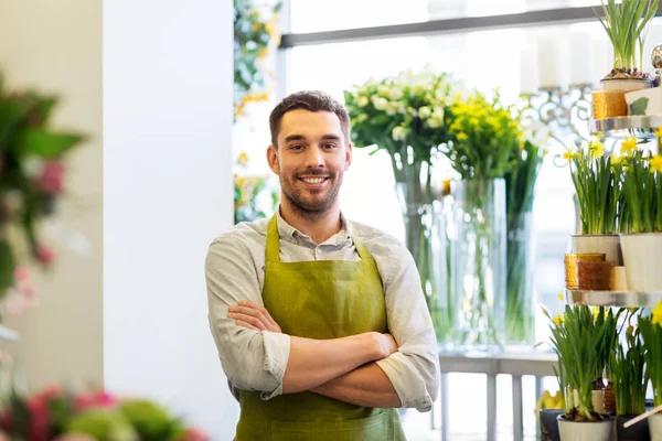 Florist man or seller at flower shop counter — Stock Photo, Image