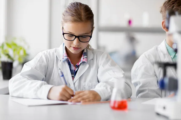 Chica estudiando química en el laboratorio escolar — Foto de Stock