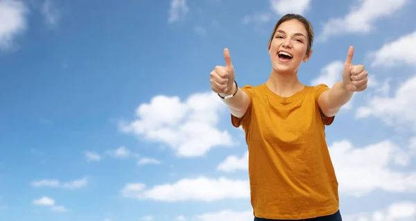 Woman or teenage girl in t-shirt showing thumbs up — Stock Photo, Image