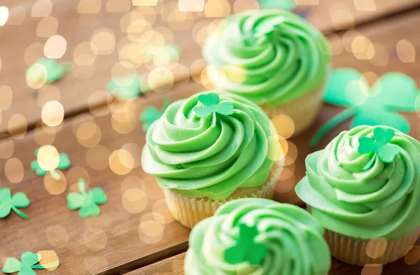 Groene cupcakes en shamrock op houten tafel — Stockfoto
