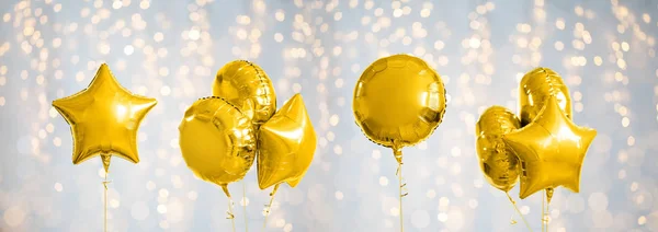 Muchos globos de helio de oro metálico en blanco —  Fotos de Stock