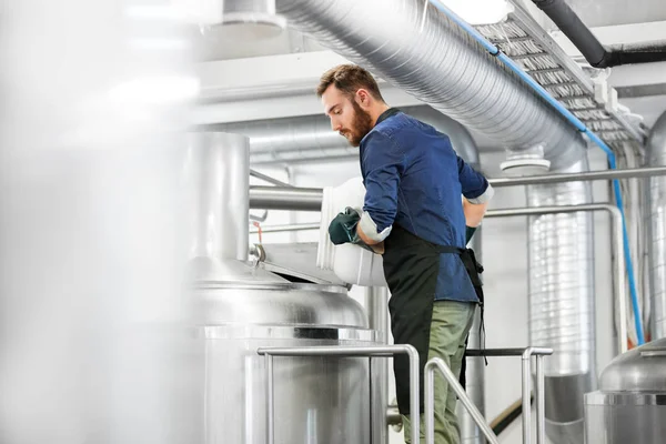 Man working at craft brewery or beer plant — Stock Photo, Image