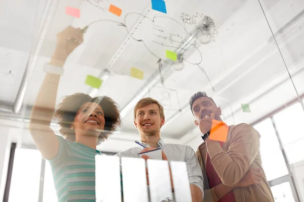 Happy creative team at office glass board — Stock Photo, Image