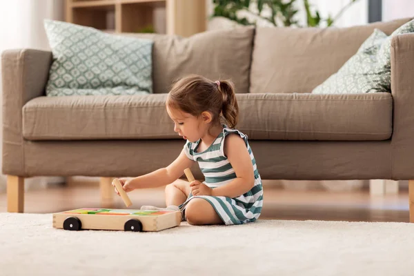 Happy baby girl playing with toy blocks at home — Stock Photo, Image