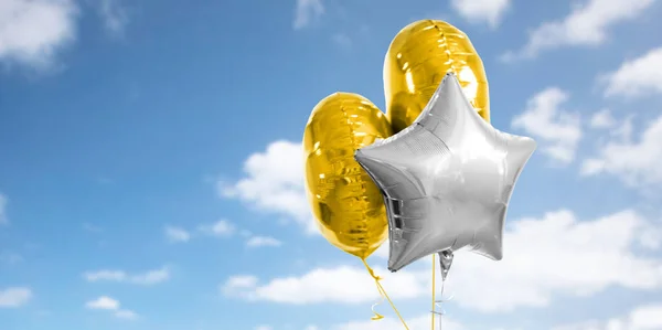 Tres globos de helio de oro y plata sobre blanco — Foto de Stock