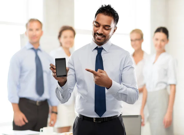Indian businessman showing smartphone at office — Stock Photo, Image