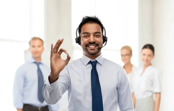 Businessman or helpline operator showing ok sign — Stock Photo, Image