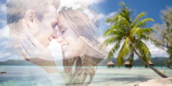 Hippie couple fading over exotic beach background — Stock Photo, Image